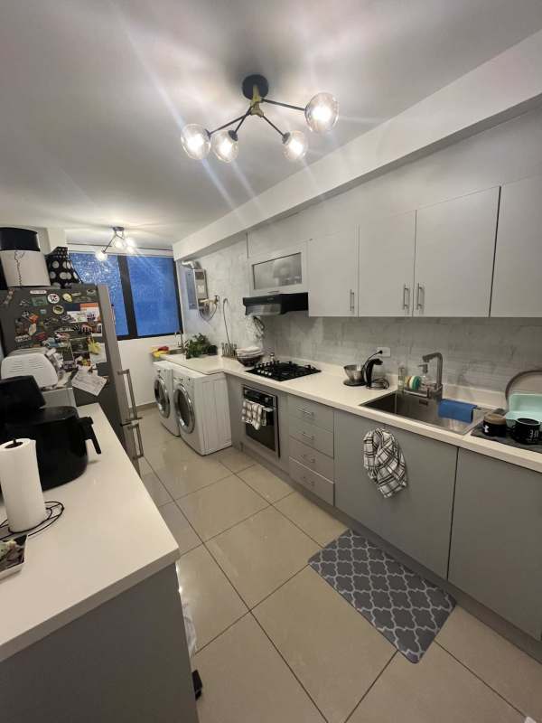 Bright bedroom with large window overlooking city San Francisco Bay Panama