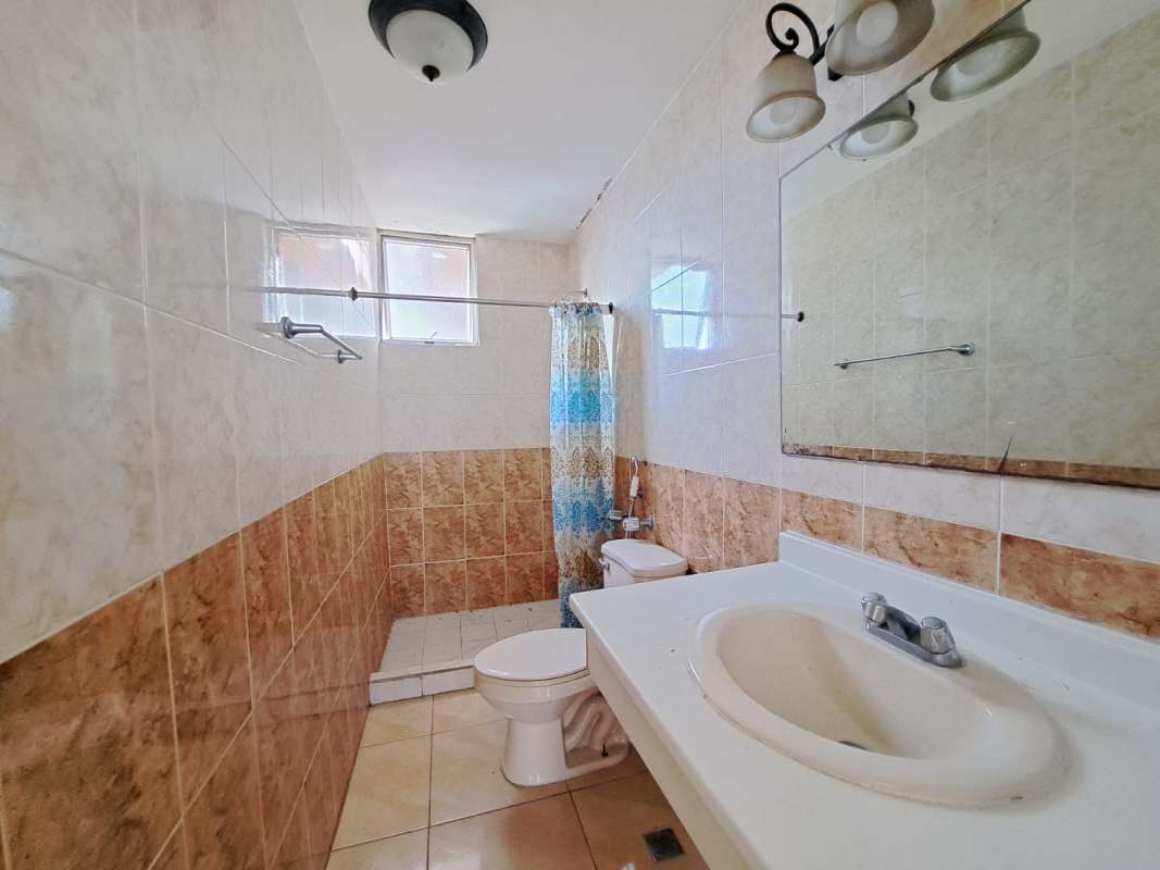 Bathroom with white vanity, mirror, walk-in shower with curtain in PH Sunset Place Panama City