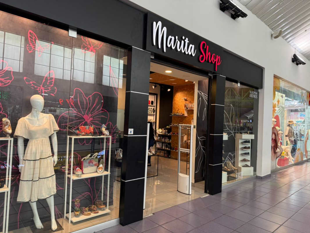 Wide corridor inside Albrook Mall with multiple storefronts Panama City