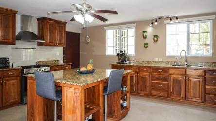 Elegant high-ceiling living room with large windows and chandelier in luxury house El Valle