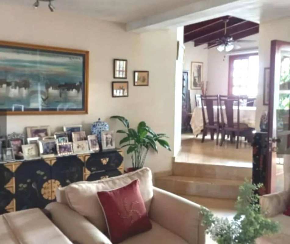 Interior stairway with decorative iron railing, wall art, light tones in Panama City 3-level house