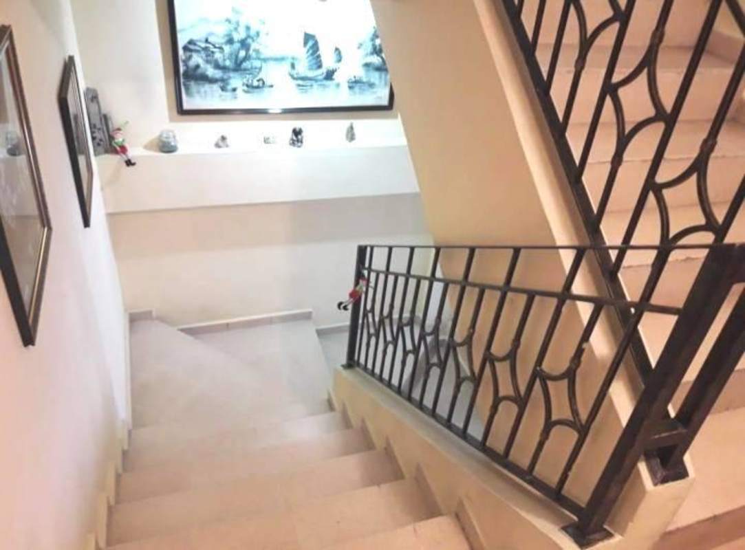 Covered outdoor patio with dining set, sofa, and greenery at house in Hato Pintado Panama City