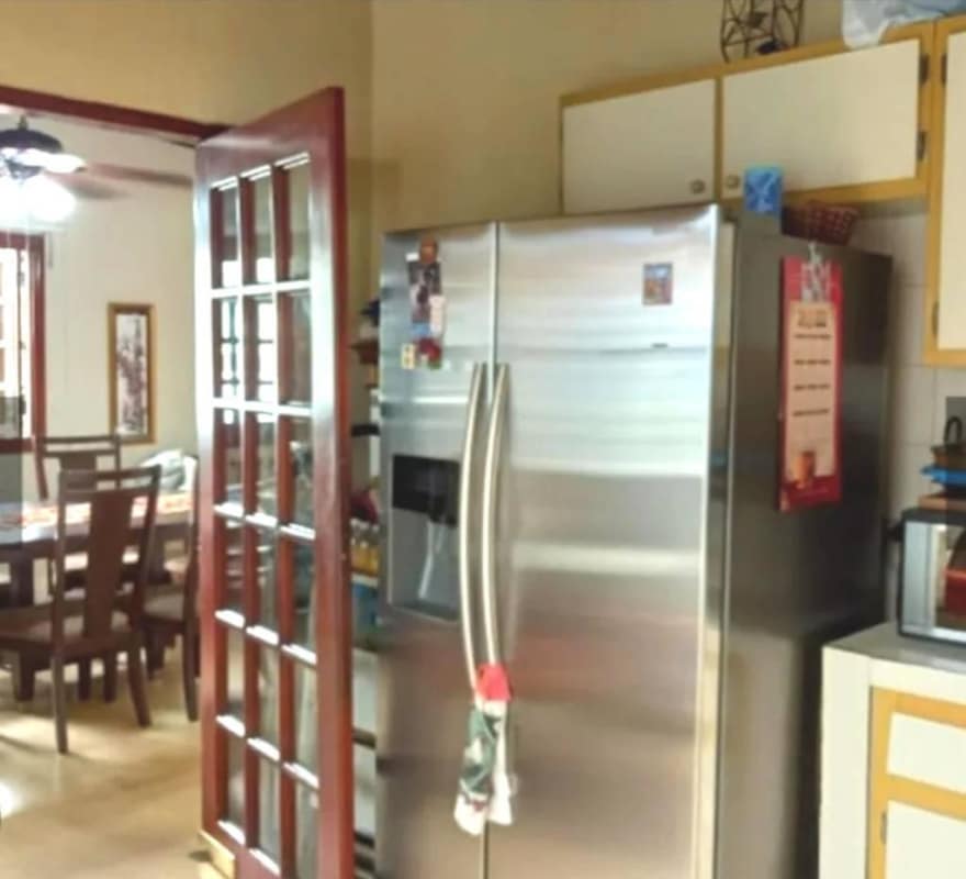 Living room connected to dining space in traditional multi-level house La Loma Panama City