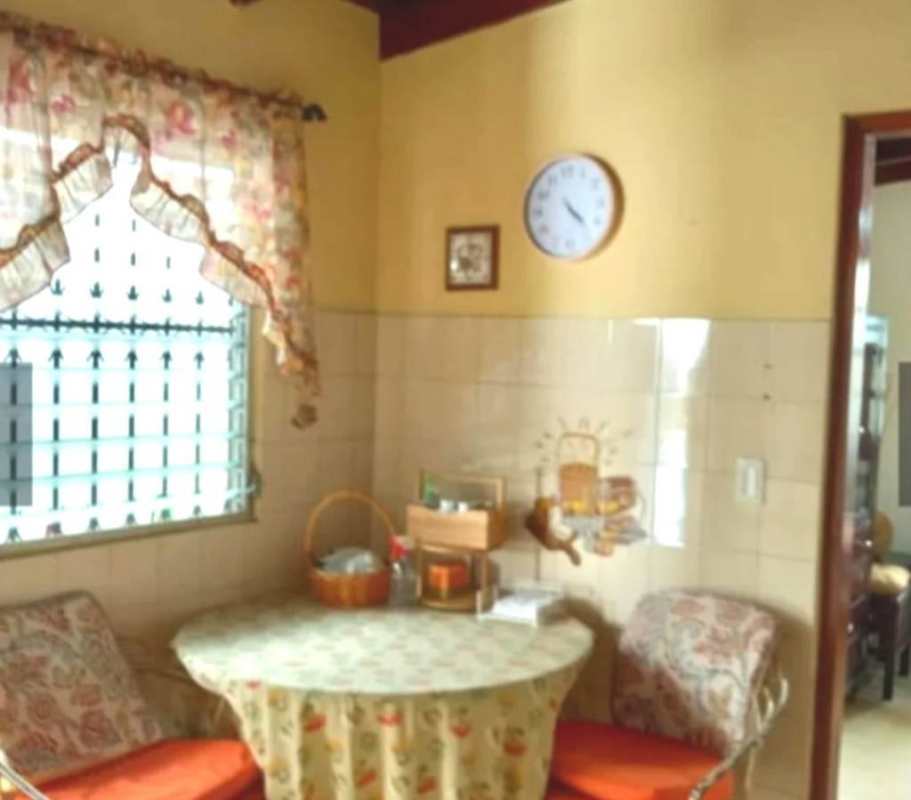 Exterior of two-story mint green house with balcony and carport in La Loma Hato Pintado Panama City