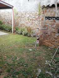 Spacious master bedroom with tile floor and window at Villas del Carrizal house for rent