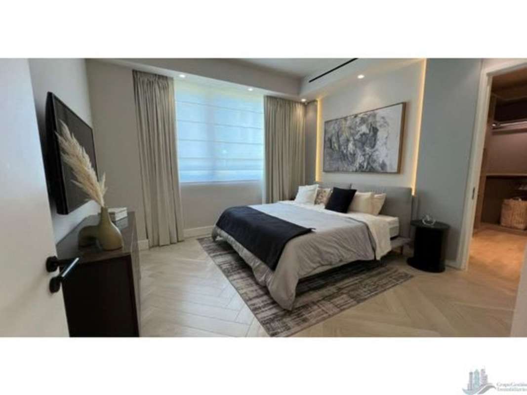 Master bedroom with floor-to-ceiling windows overlooking marina and city Ocean Reef Islands Panama