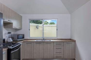 Closed kitchen with granite countertop cabinets window in PH Natura Costa Verde apartment La Chorrera