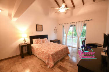 Downstairs master bedroom with ensuite bath, closet, and garden views in Costa Blanca Villas