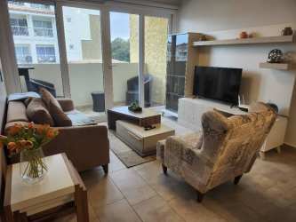 Contemporary kitchen with granite countertop and appliances in Forest Tower Tucan Panama Pacifico apartment for sale