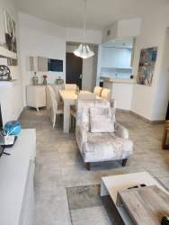 Dining area with sliding doors to balcony in apartment at Forest Tower Panama Pacifico