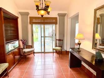 Spacious living room with large windows and comfortable seating in luxury Buenaventura villa Panama