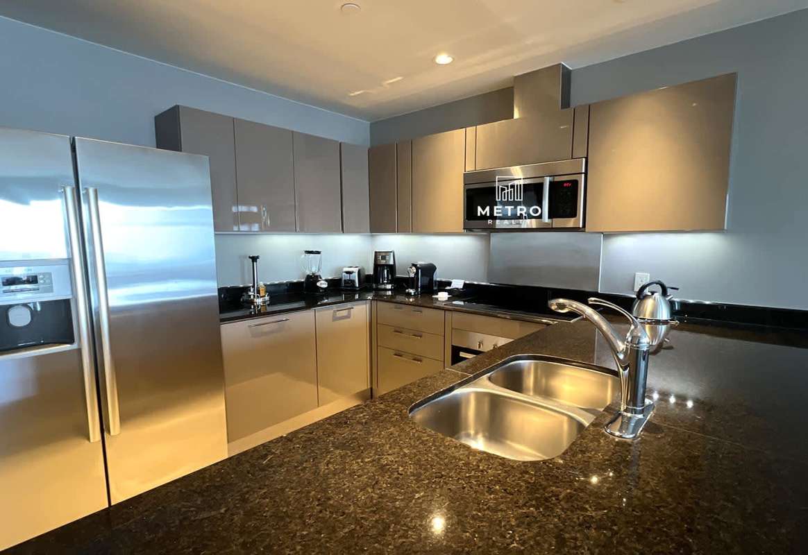 Modern bathroom with marble double vanity and glass shower in Bristol Panama suite