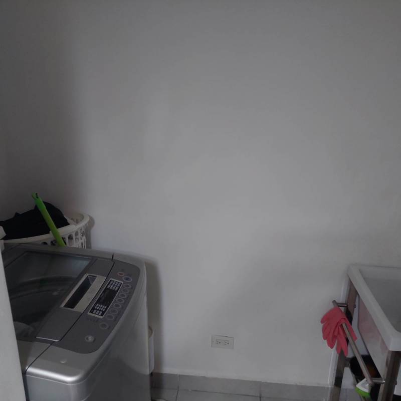 Laundry room with washing machine and utility sink in apartment behind Parque Omar Panama