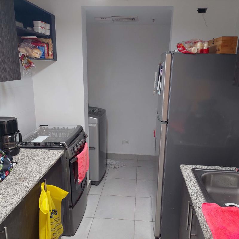 Kitchen with granite countertops and appliances in apartment near Parque Omar Panama