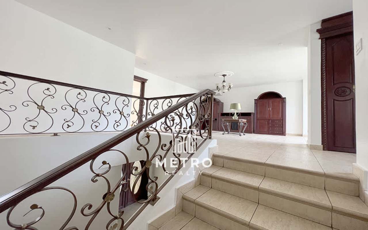 Traditional bright living room with chandelier, large windows in luxury Costa del Este Panama home