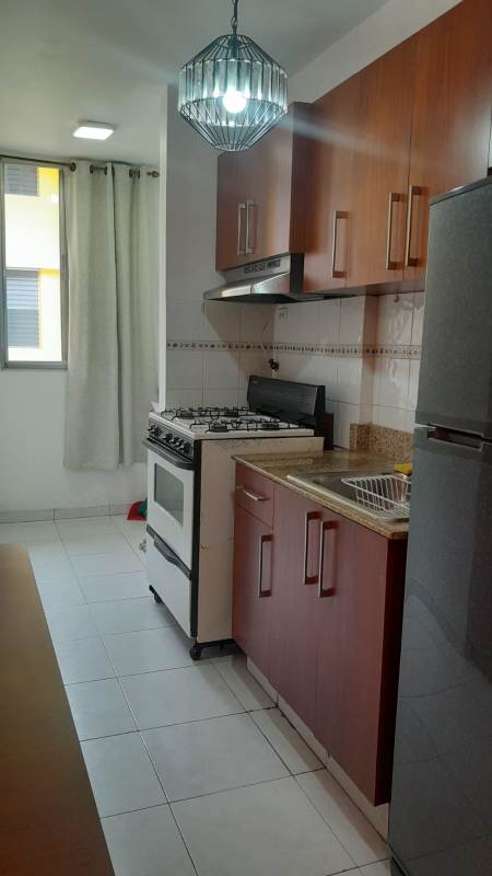 Kitchen with granite countertop, gas stove, refrigerator, upper cabinets at Villa Margarita Parque Lefevre