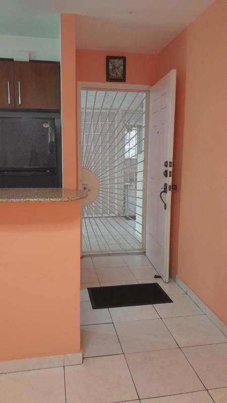 Entryway with security metal gate and open kitchen view at Villa Margarita Parque Lefevre