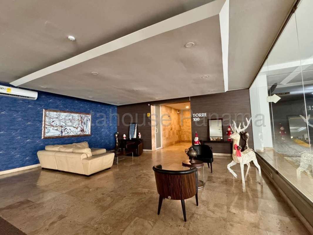 Stylish lobby with blue accent wall and seating at PH Mont Royale El Cangrejo Panama