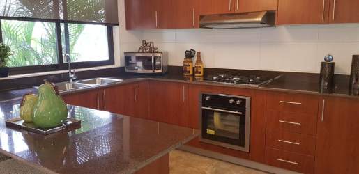 Master bedroom with large windows and porcelain tile floors in Puerto Madero Costa Verde Panama