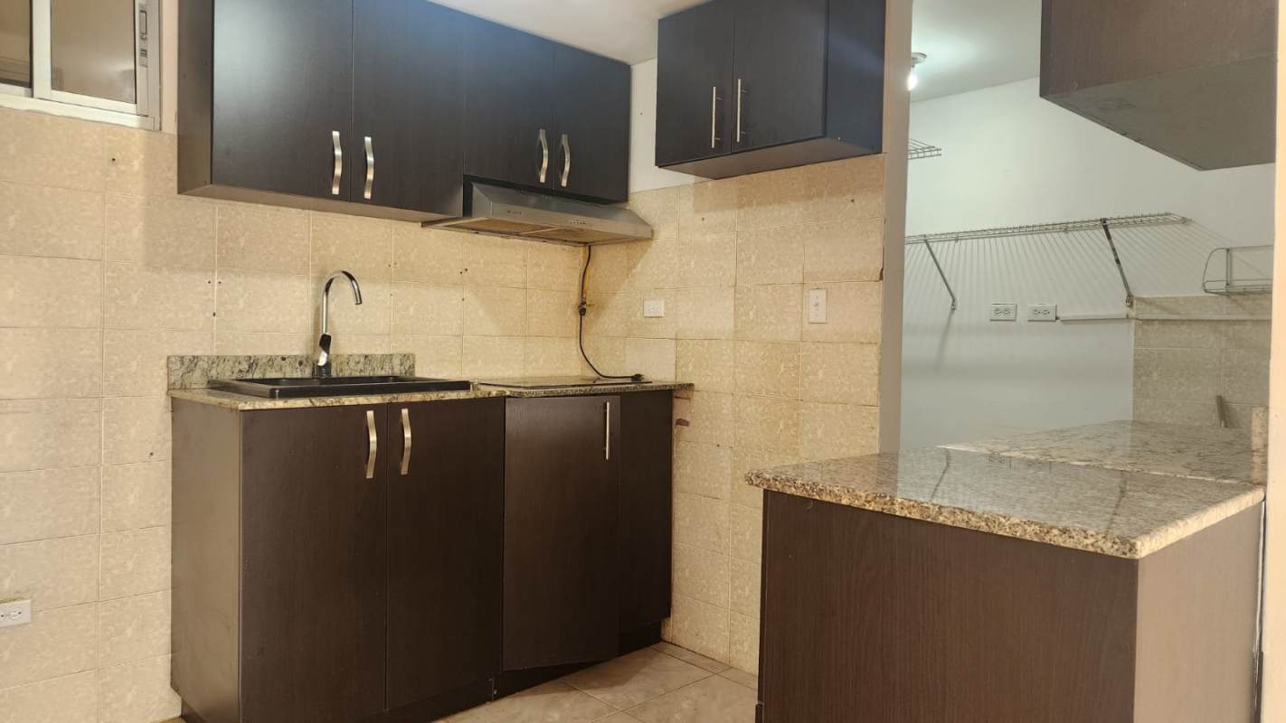 Kitchen with granite countertop, dark cabinets, tile backsplash PH Saint Anthony Hills San Antonio Panama