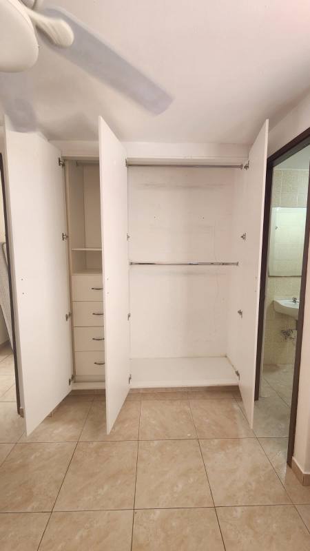 Bedroom with large window, closet, tiled floor in PH Saint Anthony Hills apartment San Miguelito Panama