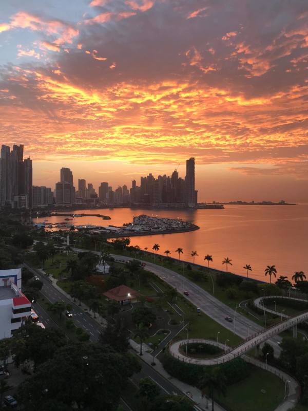 Aerial sunset view of Panama waterfront city skyline Avenida Balboa and Cinta Costera