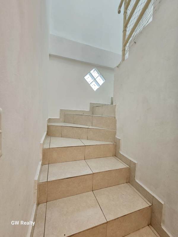 Tiled interior staircase with window PH Torres del Rey duplex apartment Panama City