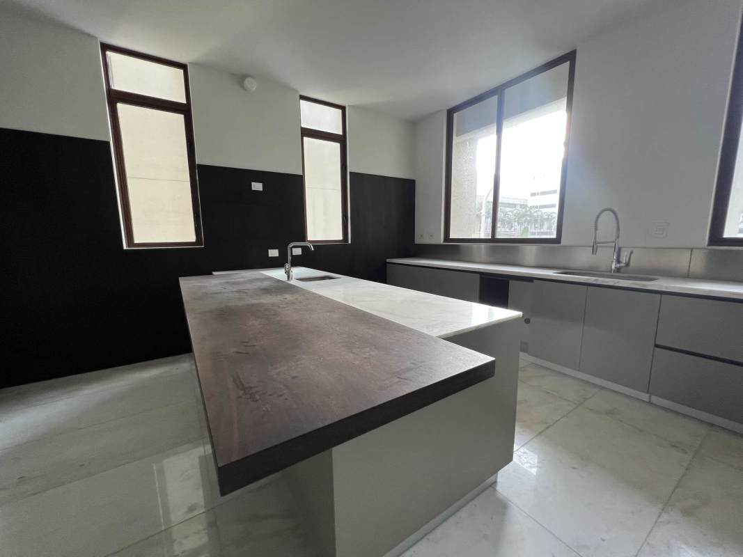 Spacious modern kitchen with center island, marble surfaces in penthouse at PH Ocean Residences Punta Pacifica