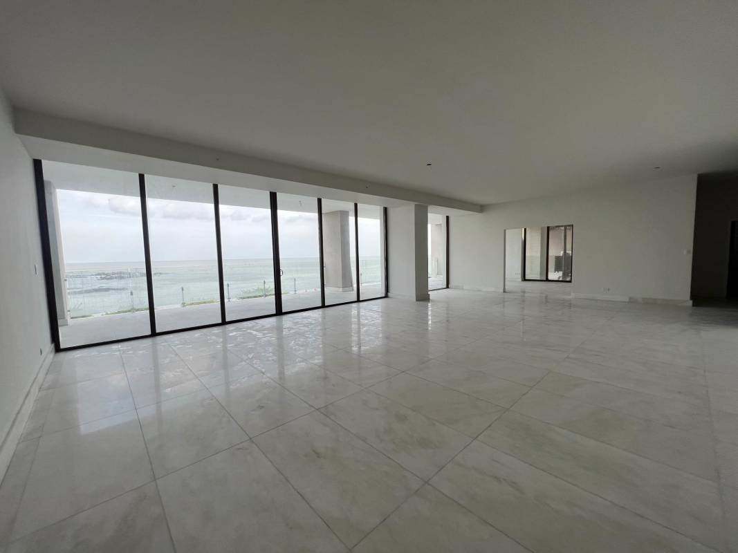 Formal dining space with marble flooring and ocean view balcony in luxury penthouse Punta Pacifica Panama