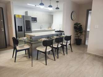 Open concept modern kitchen with cabinetry in Parterre Panama Pacifico apartment