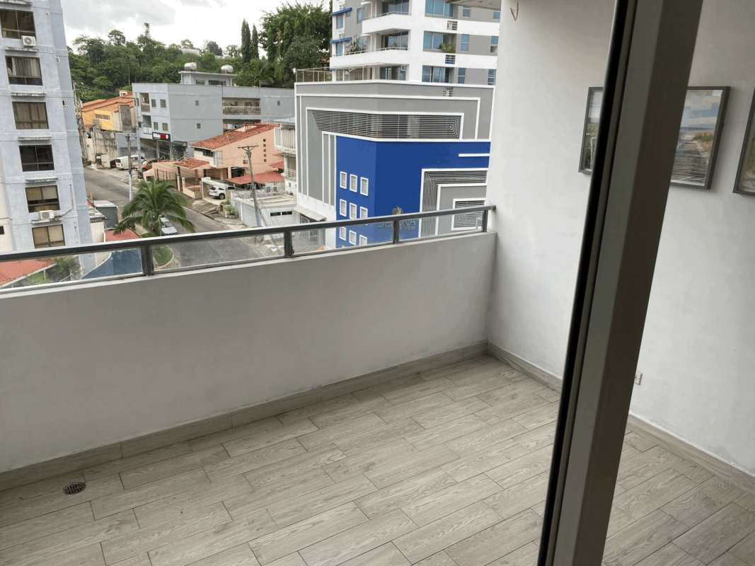 Modern apartment balcony view of city and urban surroundings Villa de las Fuentes Panama