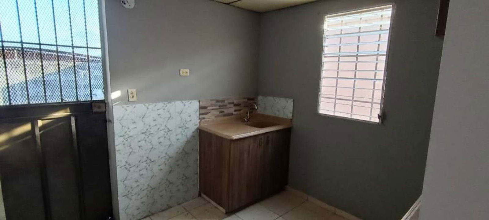 Kitchen with cabinetry and breakfast bar in affordable house for rent Altos del Angel Panama City