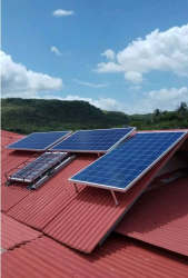 Solar panels on red metal roof with hillside view eco country home Anton Panama