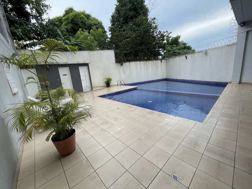 Outdoor pool with lounge space and security privacy wall at PH 12 de Octubre Panama City