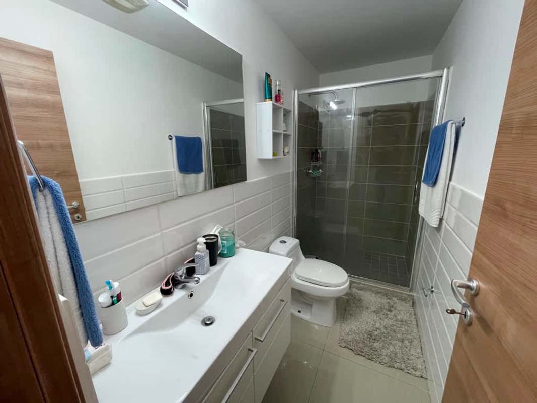 Contemporary bathroom with glass shower, vanity, large mirror in PH El Carmen Panama