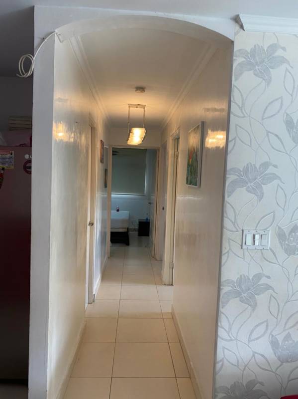 Bright hallway with decorative wallpaper and access to bedrooms PH Victory Panama City