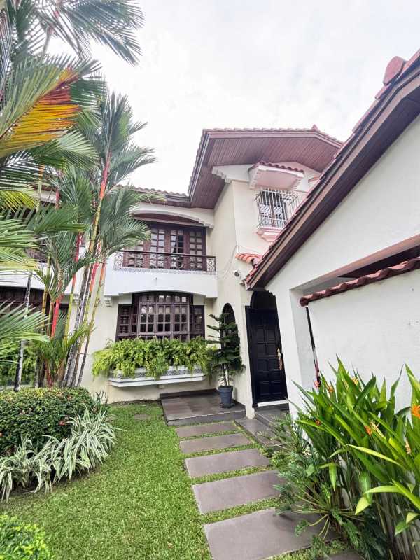 Mediterranean style home with arch windows, lush garden, balcony located in Bella Vista Panama City