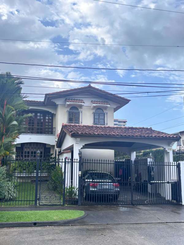 Curved private swimming pool with brick border patio and lush landscaping in El Carmen Panama