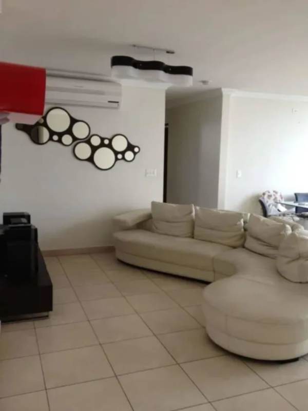 Living room with curved sofa, air conditioning, dining table PH Marbella 47 El Cangrejo Panama