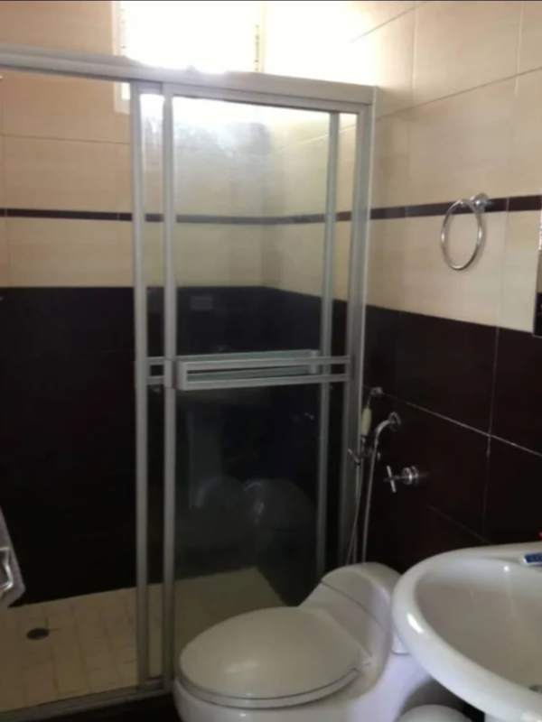 Modern bathroom with glass-enclosed shower, pedestal sink PH Marbella 47 Panama City