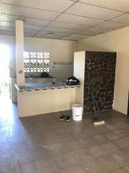 View of breakfast bar with stone details and functional kitchen inside Playa Leona house