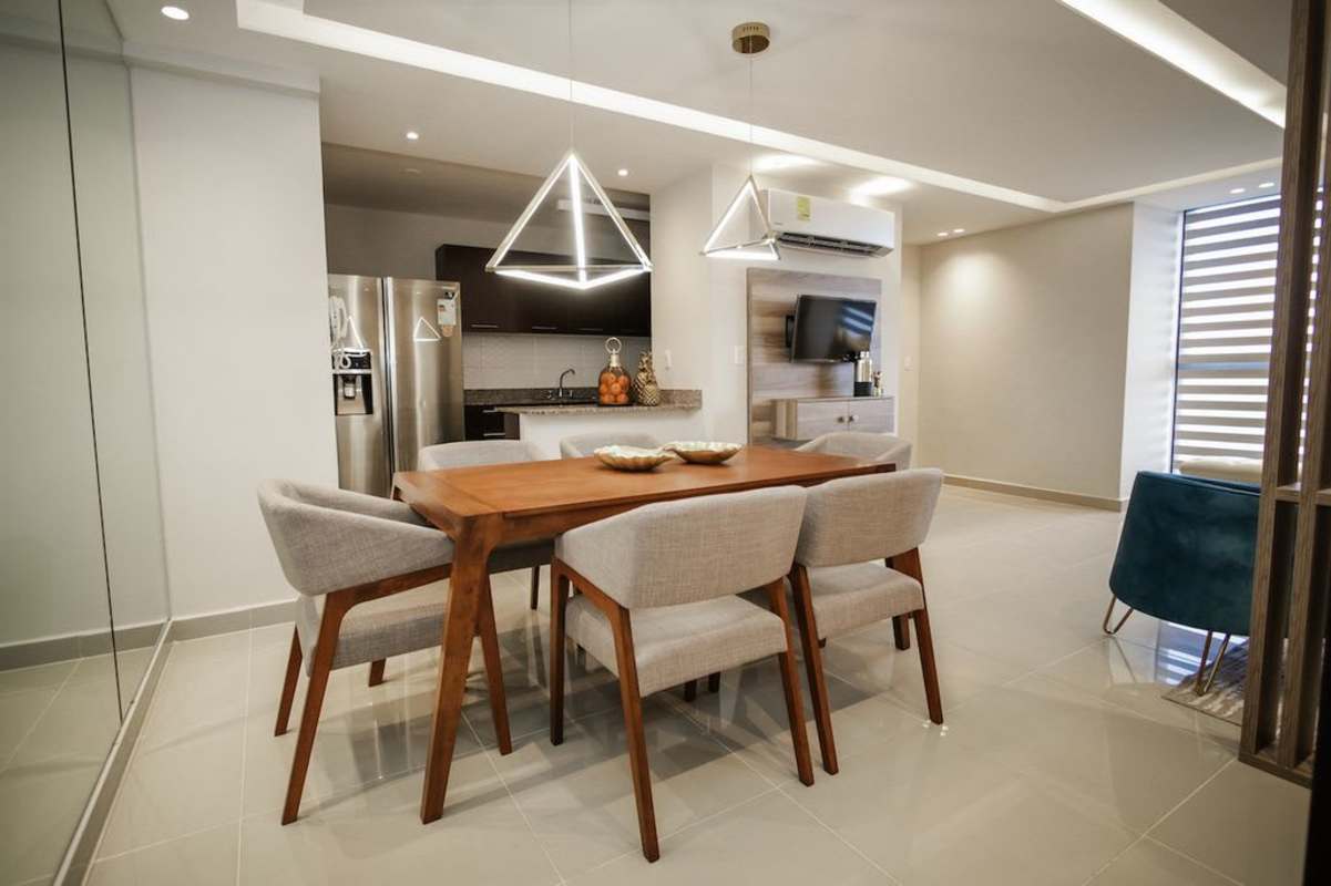 Dining area with open kitchen, modern design in Portofino Towers Panama