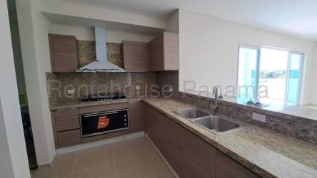 Kitchen with granite countertops, ample cabinets, and appliances in waterfront condo Panama