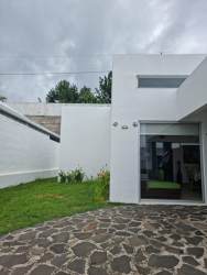 Large tropical swimming pool surrounded by palm trees at Villa Ibiza Beach Residence Rio Hato