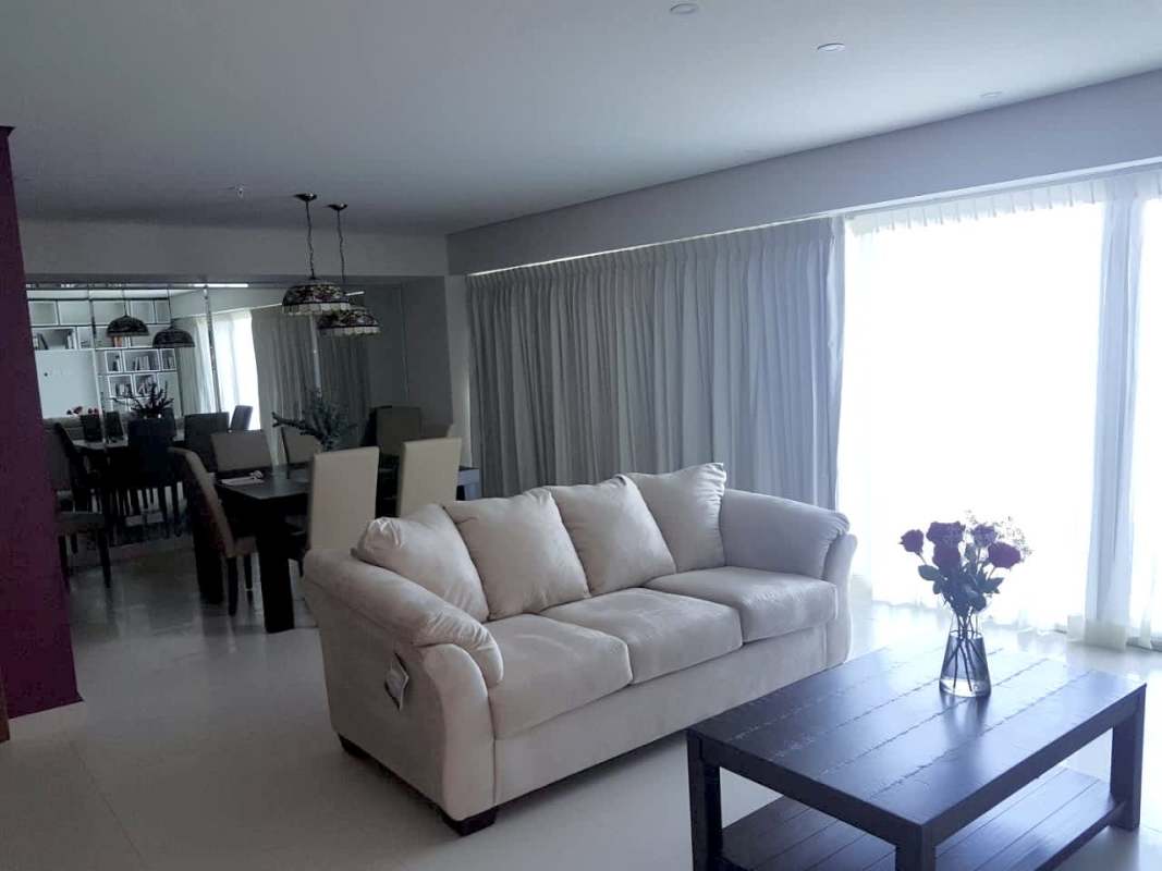 Spacious living room with kitchen island, city views in PH Parkside Costa del Este Panama
