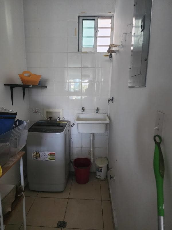 Laundry space with sink, washer hookup, and tiled walls in PH Lefevre Park Panama City