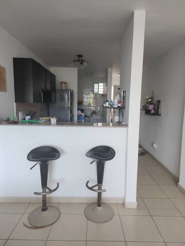 Modern open kitchen with fridge, bar stools PH Lefevre Park Panama
