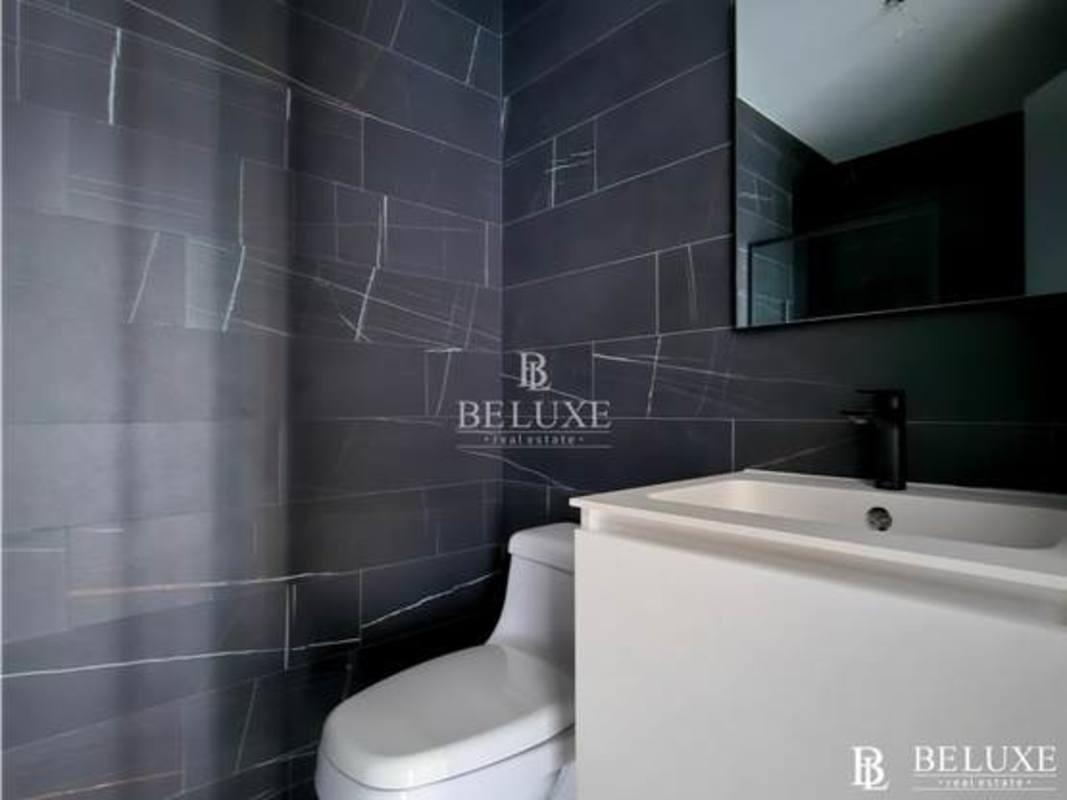 Bright bedroom with large windows overlooking Panama City skyline in Nuovo Armani