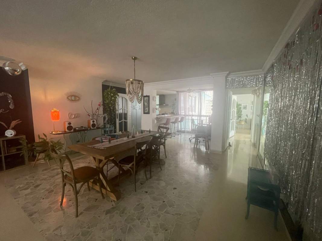 Open-plan living and dining space with marble floors, access to balcony at PH Vista Tower El Cangrejo Panama City