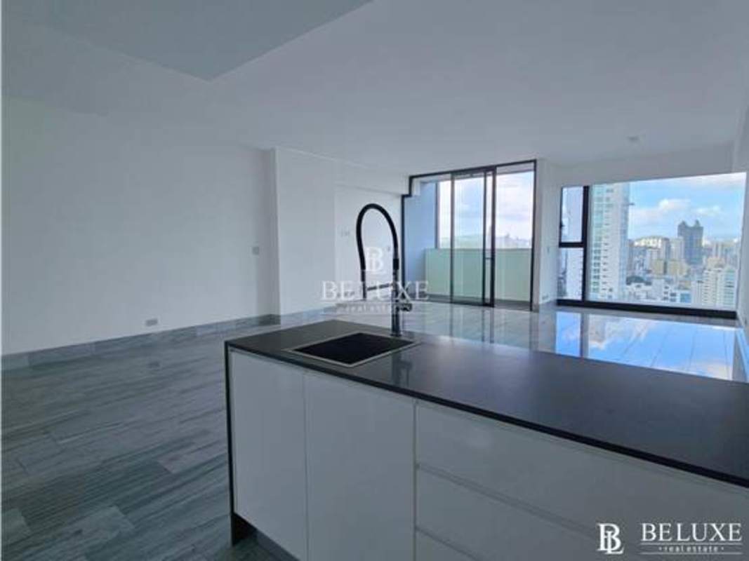 Spacious living room featuring floor-to-ceiling glass windows with ocean skyline view in PH Nuovo Armani Panama
